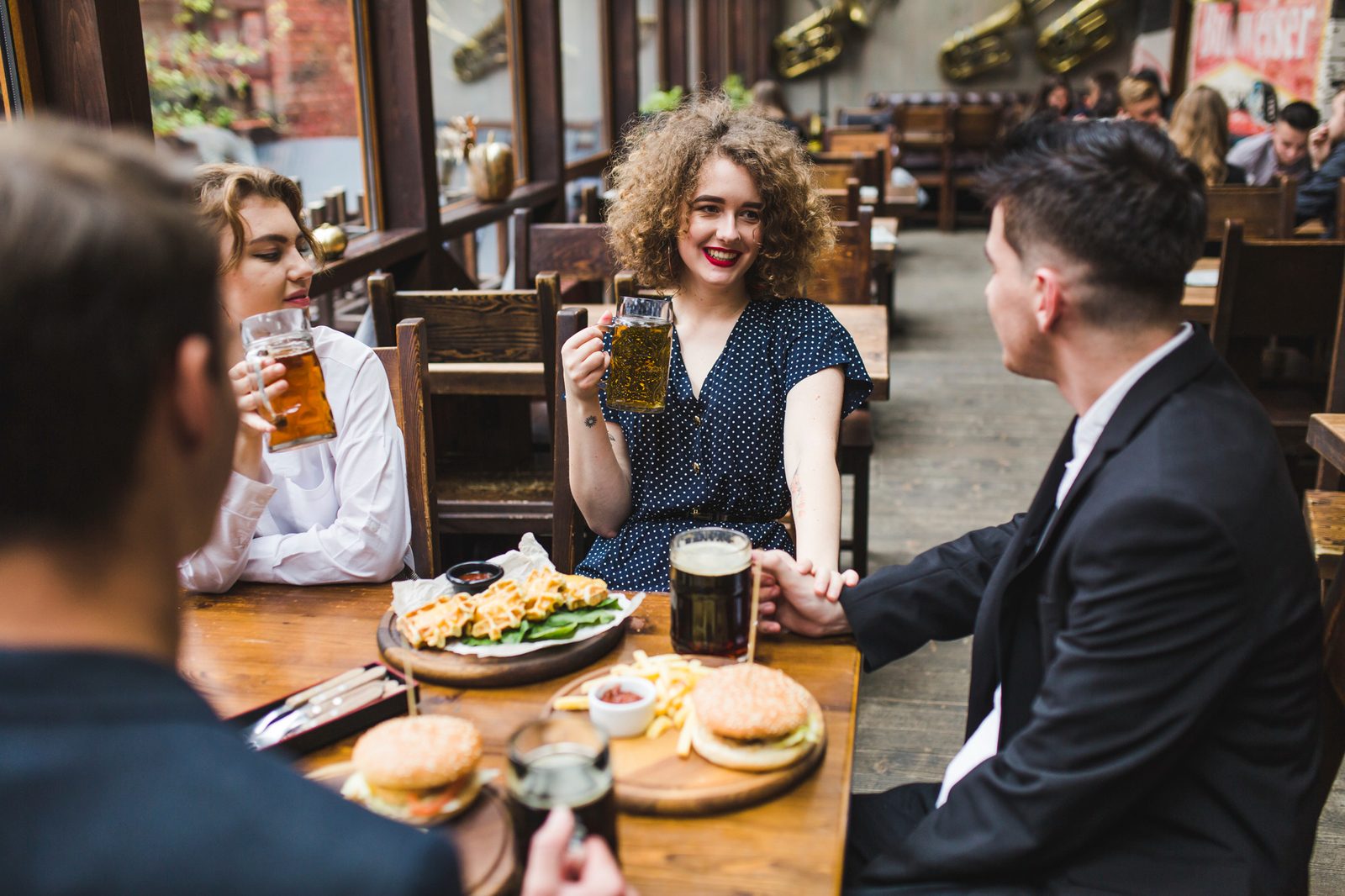 A collage showing customer interactions, daily specials, and events would be perfect here.